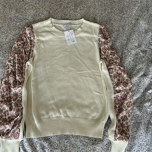 FATE Cream sweater with patterned sleeves.